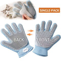 Pet grooming glove collecting loose dog fur — hair removal close-up