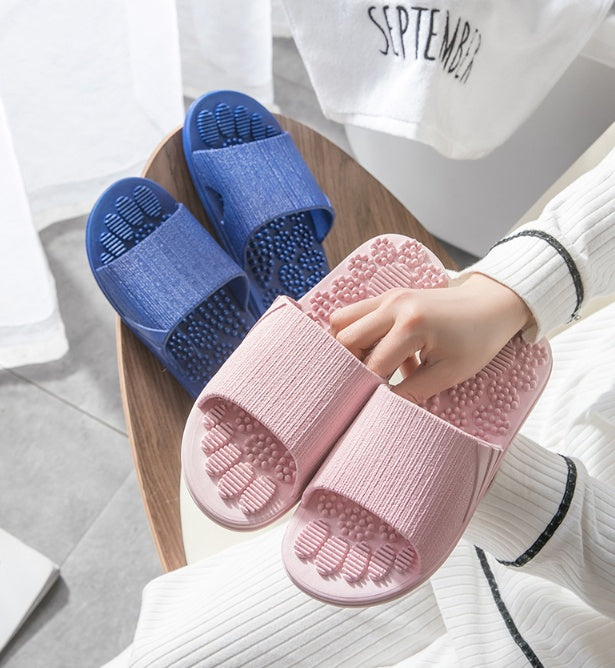 Acupressure slippers in light blue — flat lay on neutral background