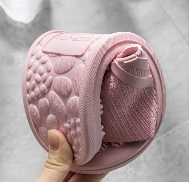Acupressure sandals in pink — lifestyle shot indoors